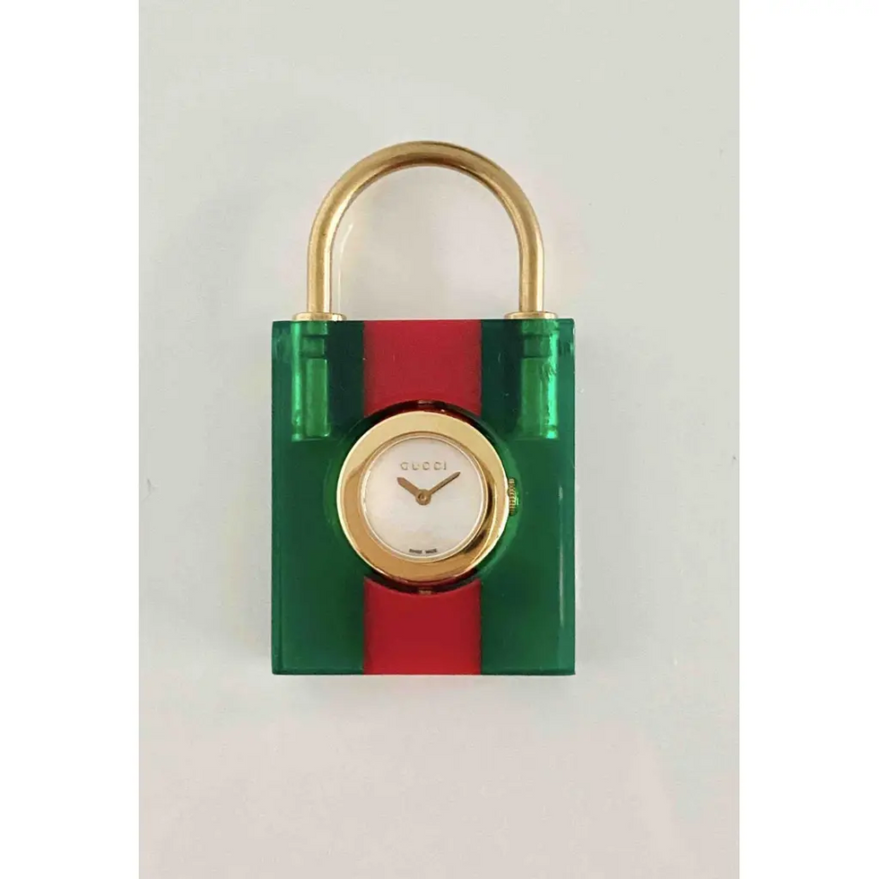 Gucci Womens Constance watch with a brown leather cuff strap, a gold